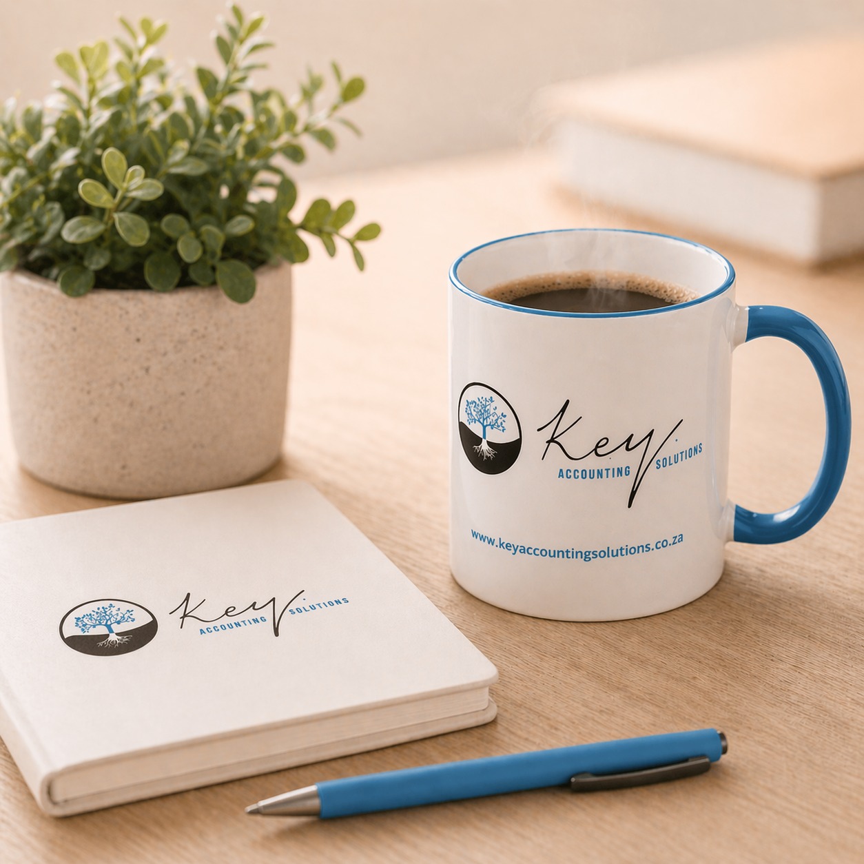 Branded mug and notebook on a desk